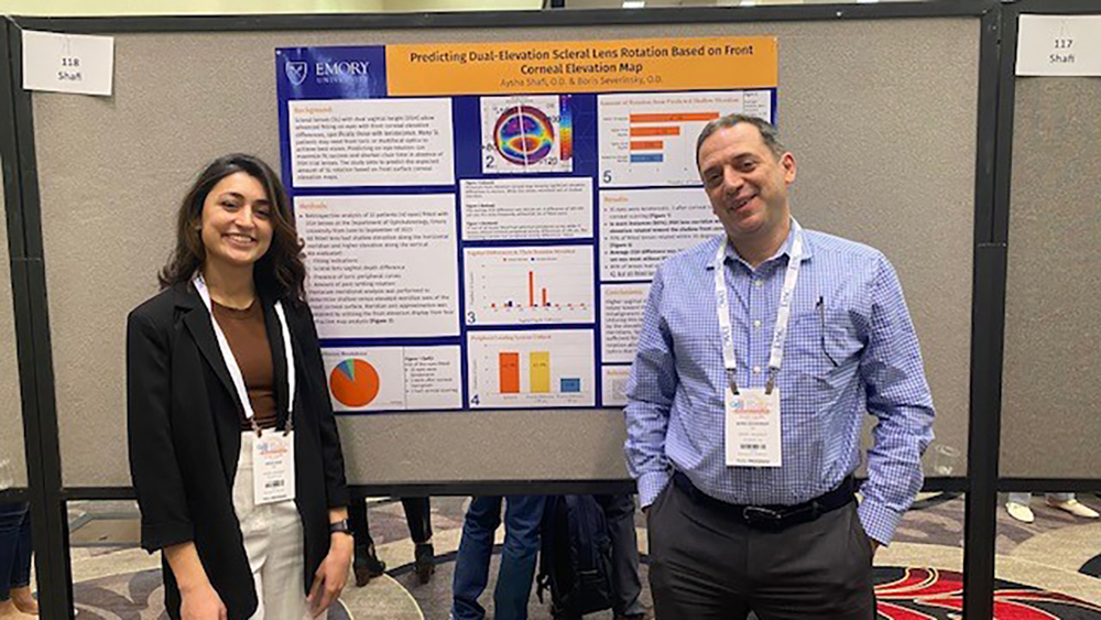 Shafi and Severinsky stand in front of their poster at the Symposium