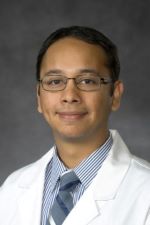 Dr. Manpreet Malik with glasses and short dark hair